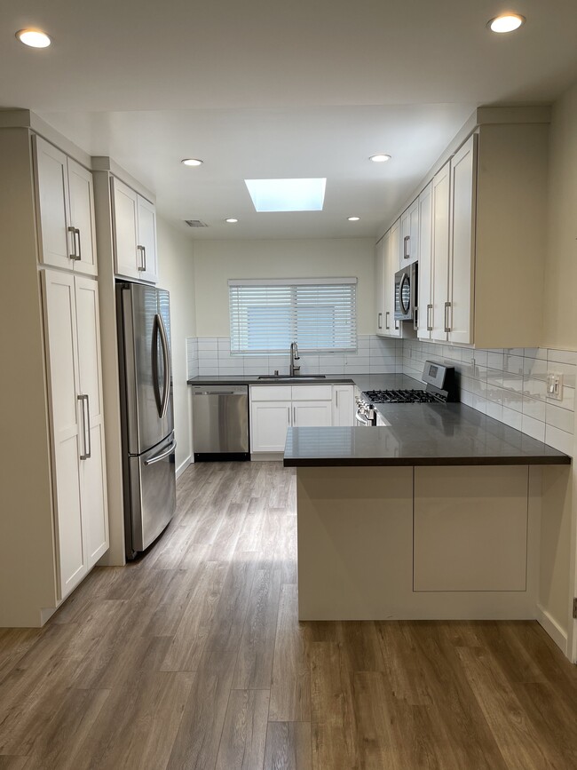 kitchen with stainless steal appliances - 4444 Fulton Ave