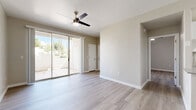 Located at 1891 N Litchfield Rd in Goodyear, AZ, this 2-bedroom, 2-bathroom single-story home offers a clean, modern aesthetic throughout. Light wood-style flooring flows seamlessly across every room, complementing the neutral warm-gray wall tones that give the space a bright, cohesive feel.

The kitchen is designed for efficiency and style, featuring white shaker cabinetry, a white subway tile backsplash, quartz countertops, and a full suite of stainless steel appliances including a refrigerator, electric range, microwave, and dishwasher. A peninsula counter extends the prep space and opens toward the living area.

The living room is airy and welcoming, highlighted by a ceiling fan, a sliding glass door that opens to a private patio, and abundant natural light. The primary bedroom is generously proportioned, offering a ceiling fan, a closet, and direct access to an en-suite bathroom equipped with a walk-in shower. The second bedroom features a large window with outdoor views and its own ceiling fan. The second bathroom includes a full tub-shower combo with white tile surround and brushed nickel fixtures. A hallway connects all rooms, ensuring a practical and intuitive layout throughout this well-appointed Goodyear home.