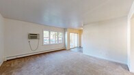 Located at 510 Maloney Road in Poughkeepsie, NY, this two-bedroom, one-bathroom residence offers a practical and comfortable single-floor layout. The living room is generously proportioned, featuring wall-to-wall carpeting, a wall-mounted air conditioning unit, baseboard heating, and large windows that invite natural light. A sliding glass door connects the living area directly to a private balcony, providing outdoor access and views of the surrounding neighborhood.

The kitchen is well-appointed with warm-toned wood cabinetry, granite-style countertops, stainless steel appliances including a range and refrigerator, a mosaic tile backsplash, and durable hardwood-style flooring. Natural light flows in through an adjacent window, adding brightness to the cooking space.

Both bedrooms are carpeted and benefit from natural light through wide windows. The primary bedroom is a comfortable size and includes a large sliding double-door closet alongside additional storage. Throughout the unit, five closets in total provide ample storage space.

The bathroom features full tile surround on the tub and shower, a white vanity with an oval mirror, and tile flooring, offering a clean and functional design. Baseboard heating is present throughout the unit, ensuring consistent warmth. A connecting hallway ties all rooms together in an efficient, well-organized floor plan.