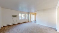 Located at 510 Maloney Road in Poughkeepsie, NY, this two-bedroom, one-bathroom residence offers a practical and comfortable single-floor layout. The living room is generously proportioned, featuring wall-to-wall carpeting, a wall-mounted air conditioning unit, baseboard heating, and large windows that invite natural light. A sliding glass door connects the living area directly to a private balcony, providing outdoor access and views of the surrounding neighborhood.

The kitchen is well-appointed with warm-toned wood cabinetry, granite-style countertops, stainless steel appliances including a range and refrigerator, a mosaic tile backsplash, and durable hardwood-style flooring. Natural light flows in through an adjacent window, adding brightness to the cooking space.

Both bedrooms are carpeted and benefit from natural light through wide windows. The primary bedroom is a comfortable size and includes a large sliding double-door closet alongside additional storage. Throughout the unit, five closets in total provide ample storage space.

The bathroom features full tile surround on the tub and shower, a white vanity with an oval mirror, and tile flooring, offering a clean and functional design. Baseboard heating is present throughout the unit, ensuring consistent warmth. A connecting hallway ties all rooms together in an efficient, well-organized floor plan.