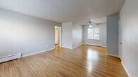 Located at 295 3rd St in Lake Oswego, Oregon, this 2-bedroom, 1-bathroom single-floor residence offers a practical and well-organized layout. Warm hardwood flooring flows consistently throughout the living areas and bedrooms, complemented by light gray walls and white trim that create a clean, neutral aesthetic. The living room is bright and open, featuring a large window that invites natural light and views of the surrounding greenery, along with a ceiling fan and baseboard heating.

The kitchen is a functional galley-style space equipped with rich dark wood cabinetry, light countertops, a mosaic tile backsplash, and stainless steel appliances, including a dishwasher and range. A window above the sink provides additional natural light.

Both bedrooms feature hardwood floors, ceiling fans, and baseboard heating. The primary bedroom includes mirrored sliding closet doors, while the second bedroom benefits from a large window with views of mature trees. The unit includes three closets in total, offering generous storage throughout.

The bathroom features a full tub-shower combination with clean white subway tile surround. A hallway connects the rooms efficiently, completing this well-maintained, move-in-ready home in a desirable Lake Oswego location.
