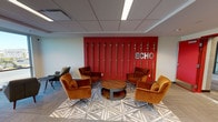 Echo is a thoughtfully designed single-floor amenity facility offering a diverse range of spaces for recreation, relaxation, and community gathering. The entrance lounge makes an immediate impression with a bold red feature wall adorned with vertical gold accents and the "ECHO" logo displayed prominently in silver lettering. A cluster of rich amber velvet armchairs surrounds a round wooden coffee table atop a geometric patterned rug, creating an inviting conversational setting.

The game room is well-appointed with a full-size pool table and a ping-pong table, complemented by colorful abstract artwork and access to natural light through exterior-facing windows. A separate area hosts an arcade cabinet and a high-top table with bar seating, further enhancing the recreational offerings.

The fitness center is generously equipped with treadmills, ellipticals, a stationary bike, a full dumbbell rack, and cable machines, all set on rubber flooring with mirrored walls and windows providing natural light.

The community kitchen features stainless steel appliances, a gas range, a large center island, tile backsplash, and wood-look flooring, with a dining area positioned beside large windows overlooking the outdoors.

A cozy media room rounds out the space, offering floor cushions, ottomans, a long wooden shelf, and a large wall-mounted television — ideal for casual screenings and relaxed gatherings.