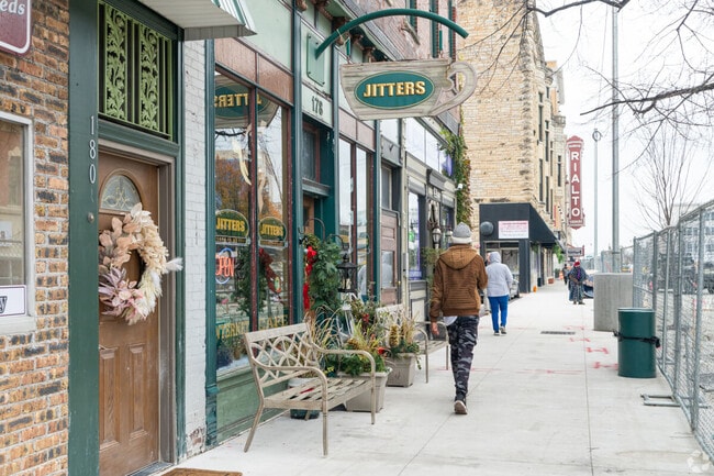 Joliet residents walk past restaurants and boutiques in the downtown area.