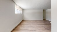 Located at 75 Mary St in Chatham-Kent, Ontario, this thoughtfully designed 2-bedroom unit offers a practical and comfortable single-floor layout. The interior is finished with light-toned laminate flooring throughout, crisp white walls, and clean white trim, creating a bright and cohesive aesthetic.

The kitchen is a functional highlight of the space, featuring white shaker-style cabinetry, grey countertops, a stainless steel refrigerator, electric range, and over-the-range microwave. A peninsula provides additional counter space and helps delineate the kitchen from the adjoining dining and living area. This open-concept common area is generously proportioned, with multiple windows fitted with roller blinds that allow natural light to filter in while maintaining privacy. Baseboard heating runs along the perimeter walls, ensuring comfort throughout the seasons.

Both bedrooms are well-sized and neatly appointed, each featuring double-door closets with clean white paneled doors and laminate flooring consistent with the rest of the unit. The primary bedroom offers a cozy yet practical footprint. A central hallway connects the living areas to the bedrooms, providing a logical and efficient flow throughout the space. The overall ambiance is clean, modern, and move-in ready.