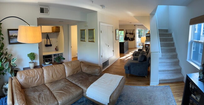 Living room with hallway back towards kitchen and blacony. - 1641 N Washington St