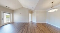 Located at 499 Boston Rd in Billerica, MA, this well-appointed one-bedroom, two-bathroom residence offers a thoughtfully designed single-floor layout with a range of appealing architectural details. The living room immediately impresses with soaring vaulted ceilings and rich hardwood-style flooring, creating an open and airy atmosphere. The space flows into a dedicated dining area, providing a natural separation between living and entertaining zones. The galley-style kitchen is efficiently designed with white cabinetry, granite-look countertops, a stainless steel refrigerator, and matching appliances, complemented by the same warm hardwood-style flooring. The spacious primary bedroom features plush carpeting and a generous bay-style window arrangement that floods the room with natural light and frames views of the surrounding greenery. Four closets throughout the unit — including a well-organized walk-in with wire shelving — provide ample storage. Both bathrooms are finished with white vanities and clean, neutral tiling. A private balcony overlooks a landscaped courtyard with pool views and mature trees. The in-unit laundry room with full-size washer and dryer adds everyday convenience, completing this functional and comfortable Billerica residence.