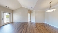 Located at 499 Boston Rd in Billerica, MA, this well-appointed one-bedroom, two-bathroom residence offers a thoughtfully designed single-floor layout with a range of appealing architectural details. The living room immediately impresses with soaring vaulted ceilings and rich hardwood-style flooring, creating an open and airy atmosphere. The space flows into a dedicated dining area, providing a natural separation between living and entertaining zones. The galley-style kitchen is efficiently designed with white cabinetry, granite-look countertops, a stainless steel refrigerator, and matching appliances, complemented by the same warm hardwood-style flooring. The spacious primary bedroom features plush carpeting and a generous bay-style window arrangement that floods the room with natural light and frames views of the surrounding greenery. Four closets throughout the unit — including a well-organized walk-in with wire shelving — provide ample storage. Both bathrooms are finished with white vanities and clean, neutral tiling. A private balcony overlooks a landscaped courtyard with pool views and mature trees. The in-unit laundry room with full-size washer and dryer adds everyday convenience, completing this functional and comfortable Billerica residence.
