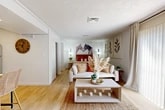 Located at 8365 Dix Ellis Trail in Jacksonville, FL, this well-appointed one-bedroom, one-bathroom unit is thoughtfully designed to maximize every inch of its cozy footprint. The open layout flows seamlessly from the living area into the kitchen, creating an efficient and inviting atmosphere throughout.

The living room is bathed in natural light streaming through a large sliding glass door framed by neutral linen drapes, offering outdoor views and a warm, airy ambiance. Light wood flooring runs throughout the home, lending a cohesive and contemporary feel.

The kitchen is a functional standout, featuring white shaker-style cabinetry with frosted glass upper panels, a bold blue hexagonal tile backsplash, light countertops, and a full suite of stainless steel appliances including a refrigerator, range, microwave, and dishwasher.

The bedroom offers a comfortable, well-proportioned retreat, complemented by two closets for ample storage. The bathroom includes a full tub-shower combination with clean, bright finishes. A dedicated utility room houses an in-unit washer, adding everyday convenience. The textured ceilings and consistent flooring throughout tie the space together into a clean, modern living environment.