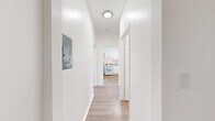 Located on the fifth floor at 432 S New Hampshire Ave in the Koreatown neighborhood of Los Angeles, this one-bedroom, one-bathroom unit offers a clean, bright, and efficiently designed living space. The open-concept living room and kitchen area serves as the heart of the unit, featuring light wood-style flooring throughout the main living areas and large windows that frame views of the surrounding Los Angeles cityscape, filling the space with natural light. The living room includes a ceiling fan and baseboard heating, providing year-round comfort. The kitchen is equipped with white cabinetry, a gas range, a full-size refrigerator, a sink, and a peninsula counter that provides additional prep space and a natural divider between the kitchen and living area. Stone-tile flooring distinguishes the kitchen zone from the wood-floored living spaces. The bedroom is a comfortable, well-proportioned room with a ceiling fan, light wood flooring, and crisp white walls. The bathroom features a tub-shower combination, a pedestal sink, a toilet, and the same warm stone-tile flooring found in the kitchen. A hallway, closet, and entrance area round out the layout, contributing to an organized and functional flow throughout the unit.