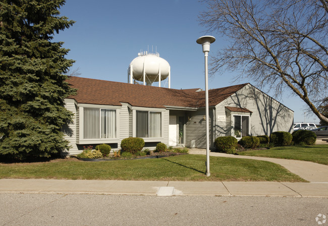 Clubhouse leasing center with pool behind - Stratford Square Apartments