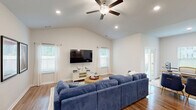 Located at 102 Jetty Dr in Pooler, GA, this well-appointed single-story home offers three bedrooms and two bathrooms within a thoughtfully designed floor plan. The living room impresses with vaulted ceilings, recessed lighting, a ceiling fan, and multiple windows that flood the space with natural light. Hardwood-style flooring flows throughout the main living areas, adding warmth and continuity.

The kitchen is a standout feature, showcasing white shaker cabinetry, granite countertops, stainless steel appliances including a French door refrigerator and range, pendant lighting, and a kitchen island with bar seating — ideal for everyday cooking and entertaining. The layout opens seamlessly into the living area, creating an inviting, connected space.

The primary bedroom is generously sized and includes a walk-in closet outfitted with wire shelving for organized storage. The primary bathroom features hardwood-style flooring, white cabinetry with granite counters, and a glass-enclosed shower. The secondary bathroom offers a full tub-shower combination. Secondary bedrooms are carpeted and bright, each with windows providing natural light. A dedicated laundry room houses a full-size Samsung washer and dryer with overhead wire shelving. The home also features a private, fenced backyard.