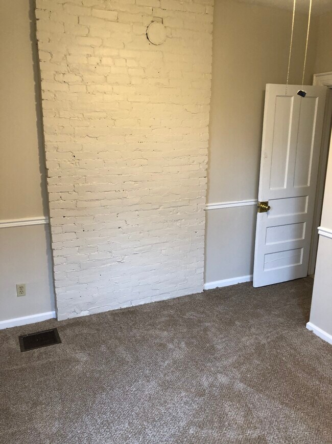Bedroom with exposed brick - 331 W Delavan Ave