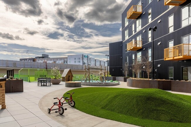 East Building Backyard amenity featuring an outdoor play area - AMLI Redmond Way