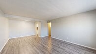Located at 7913 Harwood Rd in North Richland Hills, TX, this one-bedroom, one-bathroom unit offers a well-organized single-floor layout that makes efficient use of its space. The living room greets you upon entry with durable wood-look laminate flooring, a large window fitted with blinds that draws in natural light, and neutral-toned walls that create a clean, versatile backdrop. The layout flows openly toward the kitchen and hallway, giving the common areas a connected, airy feel. The galley-style kitchen is thoughtfully designed with white shaker cabinets, granite countertops, a mosaic tile backsplash, a stainless steel sink, and black appliances including a range and built-in microwave — all set on light wood-look flooring. The bedroom is generously sized, finished with plush carpet, a ceiling fan with light fixture, and a sliding glass door that opens to a private balcony with outdoor views. The full bathroom features a tub-shower combination, white cabinetry, granite-topped vanity, and wood-look tile flooring. A dedicated closet and hallway round out the layout, adding practical storage and seamless connectivity between rooms. The textured ceilings and consistent neutral palette give the entire unit a cohesive, move-in-ready character.