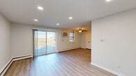 Located at 9951 Academy Rd in Philadelphia, PA, this well-appointed one-bedroom, one-bathroom unit offers a thoughtfully designed single-floor layout. The open living room is bright and inviting, featuring light wood-look flooring, recessed lighting, a ceiling fan, and a sliding glass door that leads to a private balcony with open outdoor views. Baseboard heating runs throughout the living areas, ensuring year-round comfort.

The kitchen is efficiently laid out and well-equipped, showcasing rich dark wood cabinetry, granite-style countertops, a classic subway tile backsplash, and a full suite of stainless steel appliances including a gas range, built-in microwave, and refrigerator.

The generously sized bedroom features plush carpeting, a large window for natural light, and ample closet space with double doors. A stacked washer and dryer unit is conveniently integrated into the bedroom area, adding practical in-unit laundry. The full bathroom is finished in crisp white with tile flooring, a tub/shower combination accented by a decorative mosaic tile border, and a white vanity. The overall aesthetic is clean, neutral, and move-in ready.