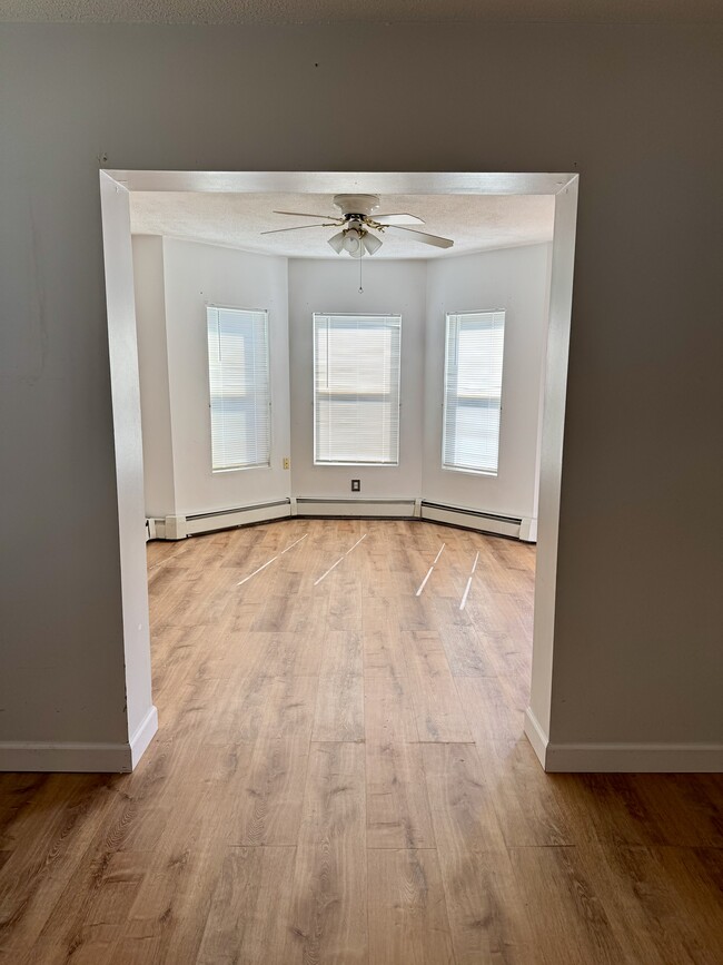 New plank flooring in living room and dining room. - 48 Balcomb St