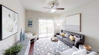 This single-floor residence at Flats of Fishers Marketplace offers a thoughtfully designed layout that balances comfort and functionality. The open-concept living and dining area is anchored by rich hardwood flooring and neutral walls that create a bright, welcoming atmosphere. A ceiling fan and sliding glass door lead to a private balcony, filling the living space with natural light and outdoor views.

The kitchen is well-equipped with warm-toned wood cabinetry, granite-style countertops, a gray subway tile backsplash, black appliances, and a double stainless steel sink accented by pendant lighting — offering both style and practicality.

Multiple bedrooms provide comfortable retreats, each featuring plush carpeting, natural light from window treatments, and ample space for furnishings. The primary bedroom is serene and softly lit, while secondary bedrooms offer versatility for guests or a home office setup.

The bathrooms are finished with tile flooring, wood vanity cabinetry, white countertops, and large mirrors. Each bathroom provides direct access to a walk-in closet, maximizing storage. One bathroom features a soaking tub with a curtained surround, while another includes a glass-enclosed shower. The overall design reflects a clean, contemporary aesthetic suited for everyday living.