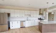 This contemporary 730 square foot apartment in Victoria, MN, offers a harmonious blend of style and functionality. The open-concept design seamlessly integrates the living room and kitchen, creating a spacious feel enhanced by large windows that flood the area with natural light. The kitchen is a standout feature, boasting pristine white cabinetry, stainless steel appliances, and ample counter space, perfect for culinary enthusiasts. The bedroom, measuring 130 square feet, provides a cozy retreat with plush carpeting and oversized windows offering urban views. The bathroom is elegantly appointed with a modern vanity, large mirror, and a combination tub-shower. Throughout the apartment, light wood-look flooring adds warmth and continuity. High ceilings and recessed lighting contribute to the airy ambiance, while the neutral color palette provides a blank canvas for personal style. This well-designed space maximizes every square foot, offering comfortable, contemporary living in a prime location.