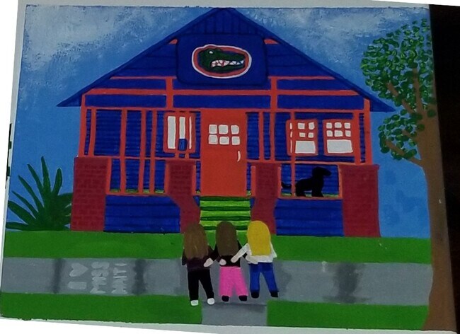 Their painting includes these three besties standing in front of their college home. - 208 NW 3rd St