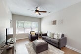 Located at 1321 Lovvorn Rd in Carrollton, GA, this single-story, 3-bedroom, 3-bathroom home offers a thoughtfully designed layout that maximizes functionality and comfort. The welcoming living room features hardwood-style flooring, a ceiling fan, and large windows that fill the space with natural light and views of the surrounding greenery, creating a bright and airy atmosphere. The kitchen is a standout feature, showcasing a granite-style peninsula countertop with pendant lighting, dark espresso cabinetry, a tile mosaic backsplash, and black appliances — all flowing seamlessly into the main living area. Each of the three bedrooms is well-sized, with the primary bedroom offering ample space and plush carpeting for added comfort. Each bedroom is paired with its own dedicated bathroom, providing privacy and convenience. The bathrooms are consistently finished with dark vanity cabinetry, single-basin sinks, and tub-shower combinations. A central hallway connects all rooms efficiently, while a dedicated utility room, laundry area, and multiple closets round out the practical features of this home. Neutral tones and clean finishes throughout contribute to a cohesive, move-in-ready aesthetic.