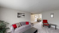 Located at 1000 Vermont Ave in Castle Shannon, PA, this single-floor residence offers a thoughtfully arranged layout comprising a living room, dining room, kitchen, bedroom, bathroom, and a dedicated office space. The living room is carpeted and open in feel, flowing seamlessly into the dining area, which is brightened by a large window with street views and features classic white radiator heating. The kitchen is equipped with white cabinetry, speckled countertops, hardwood-style flooring, a gas range, and a window that brings in natural light. The bedroom is a comfortable, carpeted retreat with a window allowing in soft, diffused light. A flexible office space, also carpeted, provides a quiet area suited for work or study, complete with natural light from a window. The bathroom features classic black-and-white tile work surrounding a full soaking tub with an overhead shower and a window for ventilation. Throughout the residence, neutral gray tones on the walls and plush carpeting create a calm, cohesive ambiance. Radiator heating is present in multiple rooms, adding a traditional character to this practical and comfortable Castle Shannon home.