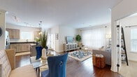 Located at 8931 N Montgall Ave in Kansas City, MO, this single-floor residence offers a thoughtfully designed open-concept layout that seamlessly connects the living, dining, and kitchen areas. Rich hardwood flooring flows throughout the main living spaces, complemented by crown molding and neutral walls that lend the interior a polished, cohesive aesthetic.

The kitchen is a standout feature, showcasing light wood cabinetry with matte black hardware, dark granite countertops, a center island with pendant lighting, stainless steel appliances, and track lighting overhead. Abundant natural light pours in through multiple windows fitted with slatted blinds. A secondary prep area with additional cabinetry and a sink provides extra functionality, with direct access to an exterior door.

The open living and dining area is generously proportioned, offering ample room for both entertaining and everyday comfort. Sheer window treatments allow soft, diffused light to fill the space throughout the day.

The bedrooms feature plush carpet, ceiling fans, and windows that invite natural light, creating calm and restful retreats. The bathroom is finished with tile flooring, a soaking tub, a glass-enclosed shower, and clean white fixtures, offering a straightforward and functional design.