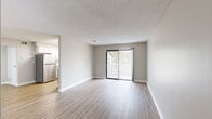 Located at 907 S Ivory Cir in Aurora, CO, this one-bedroom, one-bathroom unit offers a well-organized single-floor layout designed for comfortable everyday living. The open living room is highlighted by light wood-style vinyl flooring, neutral gray walls, a textured ceiling, and a sliding glass door that fills the space with natural light and provides access to a private balcony with outdoor views. The kitchen has been thoughtfully updated with white shaker-style cabinetry, marble-look quartz countertops, a subway tile backsplash, and stainless steel appliances including a refrigerator, range, and over-the-range microwave. A skylight and window bring additional natural light into the kitchen. The bedroom features plush wall-to-wall carpeting, a textured ceiling, a window with blinds, and a dedicated closet for storage. The bathroom is clean and functional, equipped with a full tub-shower combo, a marble-top vanity, and wood-style flooring that ties into the rest of the unit. A hallway connects the main living areas efficiently, completing the practical and cohesive floor plan of this Aurora residence.