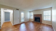 Located at 4470 S Lemay Ave in Fort Collins, CO, this one-bedroom, one-bathroom home offers a well-organized single-floor layout with a comfortable and functional design throughout. The open living room serves as the heart of the space, highlighted by warm hardwood flooring, multiple windows that invite natural light, and a classic brick fireplace that adds character and a cozy focal point to the room. A glass-paneled exterior door provides convenient access and enhances the sense of openness. The kitchen is efficiently designed with rich wood cabinetry, granite countertops, stainless steel appliances including a range, microwave, and refrigerator, and a peninsula with an undermount sink that defines the boundary between the kitchen and living area. The bedroom offers a generously sized footprint with plush carpeting, a window with natural light, and direct access to the bathroom. The bathroom features a full tub-shower combination with white tile surround, hardwood flooring, and clean, functional finishes. A hallway and closet provide additional storage, completing the practical layout. Textured ceilings are consistent throughout the home. Overall, this space delivers a warm, livable environment suited for comfortable everyday living.