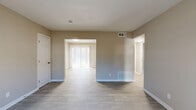Located at 3248 Chamblee Dunwoody Road in Atlanta, GA, this 2-bedroom, 1-bathroom single-floor unit offers a clean, updated living environment with a thoughtfully organized layout. The open-concept living and kitchen area is bright and airy, featuring light luxury vinyl plank flooring, neutral warm-toned walls, and sliding glass doors dressed with vertical blinds that flood the space with natural light. The kitchen is well-appointed with crisp white shaker cabinets, granite-look countertops, a stainless steel sink, a black gas range, and a black dishwasher — all arranged efficiently along a single wall. Both bedrooms are carpeted and feature natural light from windows with blinds. The primary bedroom offers a comfortable footprint with a sliding door closet, while the second bedroom provides similarly cozy accommodations. Four closets throughout the unit ensure generous storage. The bathroom features classic white subway tile surrounding a full soaking tub with a shower, chrome fixtures, and a window for natural ventilation. A connecting hallway ties all rooms together seamlessly. The overall aesthetic is clean, bright, and move-in ready, making it a functional and comfortable Atlanta-area residence.