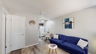 Located at 3708 S Douglas Ave in Oklahoma City, OK, this one-bedroom, one-bathroom unit is thoughtfully designed to maximize every inch of its compact footprint. The living room serves as the heart of the home, featuring wood-look plank flooring, neutral gray walls, a textured ceiling, and a large window that fills the space with natural light. A ceiling fan adds comfort, and the open sightline connects the living area directly to the dining nook and kitchen, which is equipped with a full-size refrigerator and stove. The kitchen also features dark upper cabinetry, adding contrast to the bright, clean aesthetic throughout.

The bedroom is a well-proportioned, private retreat with its own window offering natural light and outdoor views. It continues the wood-look flooring and neutral palette found throughout the unit and includes access to a dedicated walk-in closet outfitted with a hanging rod and multiple built-in shelving units, providing generous storage. The bathroom features a clean, all-white shower and tub combination. An in-unit stacked washer and dryer adds significant everyday convenience. The overall ambiance is modern, clean, and efficiently functional.