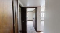 Located at 1666 Seven Pines Rd, this single-floor, 2-bedroom, 1-bathroom home offers a straightforward and efficient layout designed to maximize every square foot. The floor plan connects a central hallway to the main living areas, providing easy access throughout the space.

The two bedrooms are carpeted and finished with neutral walls, dark wood door and window trim, and textured ceilings. Each room features windows that allow natural light to filter in, with views of the surrounding exterior. The primary bedroom is notably spacious relative to the overall footprint of the home, offering ample room for standard furnishings. A dedicated closet with louvered bifold doors is accessible from the hallway, providing practical storage.

The kitchen is equipped with warm oak cabinetry extending to the ceiling, offering generous storage. White appliances including a full-size refrigerator and a coil-top range are included, complemented by light countertops and a textured ceiling.

The bathroom features a full tub-and-shower combination with a yellow surround and chrome fixtures, along with a toilet. Throughout the home, consistent dark wood baseboards and door trim create a cohesive visual style. The carpeted floors run through the bedrooms and hallway, while the kitchen features resilient flooring.