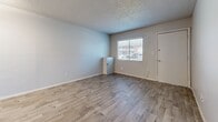 Located on W Indian School Rd in Phoenix, AZ, this one-bedroom, one-bathroom unit offers a well-organized, single-floor layout designed for efficient living. Light-toned wood-look flooring runs consistently throughout the space, lending a clean, cohesive aesthetic to every room.

The combined kitchen and living area serves as the heart of the unit. The kitchen is equipped with white cabinetry, a stainless steel refrigerator, a gas range, and a single-basin sink — all set against a light, neutral color palette. A flush-mount ceiling light provides steady illumination, and a window allows natural light into the kitchen area.

The living room is open and straightforward, featuring neutral gray walls, textured ceilings, and a window fitted with blinds that invites natural light while maintaining privacy. The bedroom is a comfortable, well-proportioned room with its own window, a closet, and the same wood-look flooring, creating a calm and restful atmosphere.

The bathroom includes a full tub-shower combo with white tile surround, a toilet, and a vanity with a stone-look countertop and wood cabinetry. Brushed nickel fixtures and hardware complete the clean, functional design. Overall, this unit offers a tidy, move-in-ready living environment in a central Phoenix location.