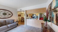 Located in Tucson, AZ, this 2-bedroom, 1-bathroom single-floor residence offers a thoughtfully arranged layout that maximizes its compact footprint. The open-concept living area features plush carpeting and a sliding glass door that fills the room with natural light while providing access to an outdoor patio with views of the surrounding landscape. Adjacent to the living room, the dining area showcases wood-look flooring, a tray ceiling detail, and a cozy atmosphere ideal for intimate meals. The kitchen is designed with efficiency in mind, featuring warm wood-toned cabinetry, stainless steel appliances including an electric range, over-the-range microwave, and refrigerator, all accessible via a convenient half-wall pass-through that connects seamlessly to the living and dining spaces. The primary bedroom offers comfortable carpeting, a window with outdoor views, and a closet, while the second bedroom also includes a closet and easy access to the shared hallway. The bathroom is finished with a wood-toned vanity, a wide mirror with overhead lighting, and wood-look flooring. A dedicated laundry area with a stacked washer and dryer unit adds everyday convenience. This well-appointed Tucson residence combines functional design with comfortable living throughout.