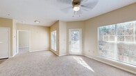 Located at 461 Old Dixie Way in Forest Park, GA, this single-floor, one-bedroom, one-bathroom home offers a practical and comfortable layout with warm neutral tones throughout. The combined kitchen and living area forms the heart of the home, where vaulted ceilings add a sense of openness and a ceiling fan provides year-round comfort. Multiple windows and a private exterior door flood the carpeted living space with natural light and provide outdoor access. The kitchen is laid out in a galley style, featuring white cabinetry with wood-tone trim, stainless steel appliances including a refrigerator and electric range, white countertops, and wood-look flooring that adds a clean, modern touch. A peninsula counter connects the kitchen to the living area, ideal for casual dining or additional prep space. The bedroom is a well-proportioned retreat with plush carpeting, a large window overlooking the outdoors, and direct access to both a dedicated closet and the full bathroom. The bathroom is equipped with a single-sink vanity with white cabinetry, a large mirror, a tiled shower-tub combination, and wood-look flooring. This home offers a cohesive and functional living experience in a convenient Forest Park location.