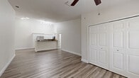 Located in New Port Richey, Florida, this single-story 2-bedroom, 2-bathroom home offers a clean, modern aesthetic throughout. The open-concept kitchen and living area forms the heart of the home, anchored by a well-equipped kitchen featuring white shaker cabinetry, granite countertops, a subway tile backsplash, stainless steel appliances, and a breakfast bar peninsula ideal for casual dining or entertaining.

The bedrooms are generously sized, each showcasing vaulted ceilings that enhance the sense of space and airiness, along with ceiling fans, wood-look luxury vinyl plank flooring, and large windows fitted with blinds that invite natural light while maintaining privacy. The primary bedroom is particularly spacious and connects to an en-suite bathroom finished with marble-look tile flooring, a granite-topped double vanity with white cabinetry, and a tiled shower surround. Walk-in closets with wire shelving systems provide ample storage throughout.

The second bedroom features a double-door closet and similarly airy proportions. A total of three closets across the home ensure excellent storage capacity. Consistent neutral tones, crisp white trim, and cohesive flooring materials create a unified, contemporary feel from room to room, making this home a comfortable and stylish residence.