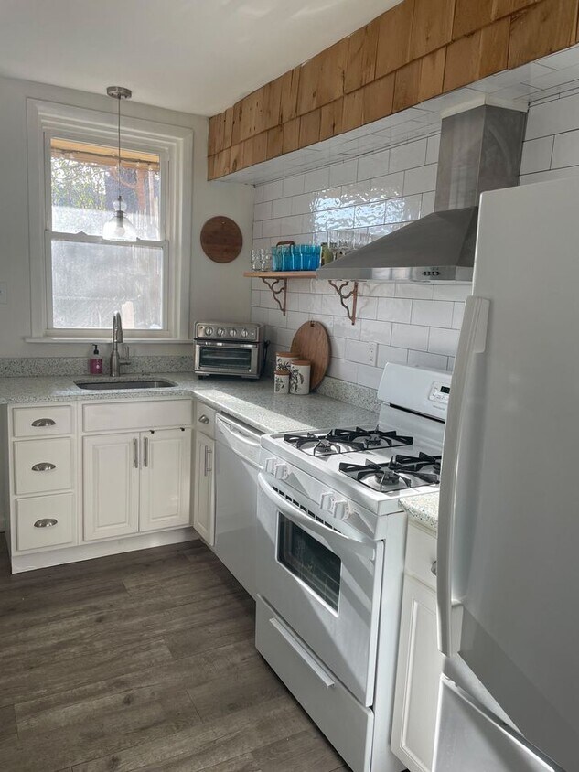 Sunny kitchen with recycled glass countertops and open shelving - 2955 Chatham St