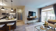 Located at 372 Wheelers Farms Rd in Milford, Connecticut, this single-floor residence offers a thoughtfully designed layout with modern finishes and a cohesive contemporary aesthetic throughout. Light wood-style flooring runs seamlessly across the open-concept living, dining, and kitchen areas, creating a warm and unified feel.

The kitchen is a standout feature, showcasing rich wood-tone cabinetry with sleek hardware, white quartz countertops, a classic subway tile backsplash, and a full suite of stainless steel appliances including a gas range, built-in microwave, dishwasher, and French door refrigerator. A central island with pendant lighting and bar seating makes the kitchen ideal for both cooking and casual dining.

The living area is bright and inviting, highlighted by a geometric accent wall, large windows admitting generous natural light, and access to an outdoor balcony. The adjacent dining space features an elegant chandelier and a bold navy accent wall, adding depth and character.

The bedroom is generously proportioned, featuring a striking navy accent wall with framed gallery art, a large window with outdoor views, and direct access to both a bathroom and a walk-in closet. The bathroom includes a full soaking tub and shower combination with gold-tone fixtures and neutral tile flooring.