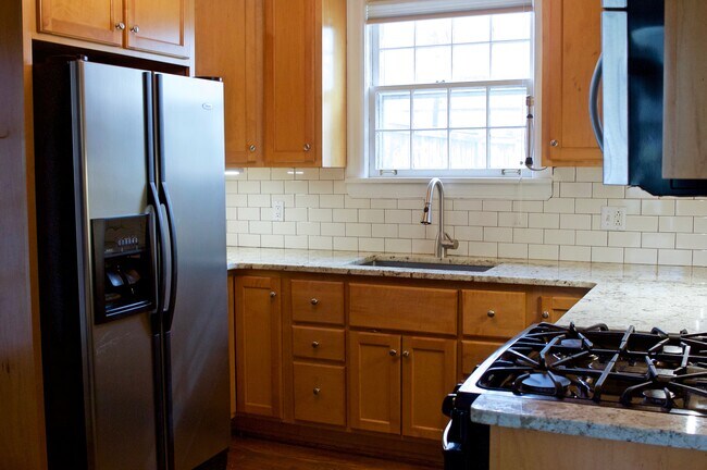 Chef's galley kitchen with stainless sink and freshly resealed Bordeaux granite countertops - 1509 HARWOOD DR