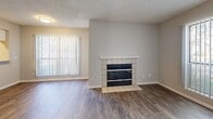 This one-bedroom, one-bathroom residence in Northglenn, Colorado offers a thoughtfully designed layout across a single floor. The living room serves as the central gathering space, featuring wood-style flooring, neutral gray walls, and a tile-surround fireplace with a white mantel that adds warmth and character. Vertical blinds on the windows allow for natural light while maintaining privacy.

The kitchen is outfitted with stainless steel appliances — including a refrigerator, electric range, and over-the-range microwave — complemented by crisp white shaker-style cabinetry and light marble-look countertops. Wood-style flooring continues throughout this space, creating a cohesive flow from the living area.

The bedroom is a comfortable, carpeted retreat with neutral tones, offering a calm and restful atmosphere. A closet provides convenient storage, and a window dressed with vertical blinds brings in natural light.

The bathroom is clean and functional, featuring a marble-look vanity countertop, a large mirror with overhead lighting, wood-style flooring, and accessibility-friendly grab bars. The entry area includes an additional closet, adding practical storage to the overall layout. This residence combines modern updates with a straightforward, efficient design suited for comfortable everyday living.