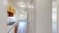 Located at 6276 12th St N in Oakdale, Minnesota, this 2-bedroom, 1-bathroom unit offers a practical and comfortable single-floor layout. The open-concept living, dining, and kitchen area serves as the heart of the home, featuring light luxury vinyl plank flooring that transitions seamlessly throughout the common spaces. The kitchen is equipped with warm wood-toned cabinetry, a white appliance suite including a refrigerator and range, and a sink with ample counter space. A pantry provides additional storage, and a ceiling fan overhead keeps the living area comfortable year-round. Natural light filters in through multiple windows, offering views of the surrounding neighborhood. Baseboard heating is present throughout, ensuring consistent warmth during Minnesota winters. Both bedrooms are carpeted and well-sized, each featuring windows that bring in natural light and closet storage — with the primary bedroom offering a notably generous footprint. The full bathroom includes a single-sink vanity with wood cabinetry, a tub-shower combination, and LVP flooring. With four closets total, storage is abundant throughout this well-appointed unit.