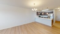 Located at 32015 Azure Ave in Rehoboth Beach, Delaware, this single-floor residence offers a clean, modern design with a bright and open interior. The entry hallway welcomes you with light-toned luxury vinyl plank flooring and convenient wall hooks, leading seamlessly into the main living area.

The open-concept living and dining area is finished with the same light hardwood-style flooring and features an elegant chandelier and ceiling fan, along with multiple windows fitted with blinds that allow generous natural light. A wall-mounted HVAC unit ensures year-round comfort.

The kitchen is well-equipped with rich dark cabinetry, stainless steel appliances including a refrigerator, range, and microwave, complemented by crisp white countertops. A large kitchen island with a built-in sink and pendant lighting serves as both a functional workspace and a casual dining spot.

The bedrooms are carpeted for comfort, each outfitted with ceiling fans and windows providing natural light. The two bathrooms are finished with dark wood vanities and white countertops; one features a tub/shower combo, while the other offers a glass-enclosed walk-in shower with light tile flooring. The overall aesthetic throughout is fresh, neutral, and move-in ready.