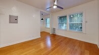 Located at 1412 N Kingsley Dr in Los Angeles' East Hollywood neighborhood, this efficiently laid-out single-floor unit makes smart use of its intimate footprint. Warm-toned hardwood flooring runs throughout, lending a cohesive and inviting feel to the entire space.

The living room is bright and airy, featuring a ceiling fan with integrated lighting and windows with blinds that frame views of surrounding greenery, allowing natural light to filter in. Recessed lighting and clean white walls further enhance the open, well-lit atmosphere.

The combined dining and kitchen area flows naturally from the living space and is outfitted with white cabinetry, dark countertops, a stainless steel refrigerator, and a gas range. A pendant light adds a touch of character to the dining portion of the room, while additional windows continue to bring in natural light.

The bathroom is finished in a clean, all-white palette, featuring a single-vanity with under-cabinet storage, a wall-mounted mirror, and a full bathtub with a shower fixture — practical and neatly maintained.

A closet provides dedicated storage, rounding out the functional layout of this well-appointed unit. Overall, the space offers a clean, move-in-ready environment in a prime Los Angeles location.
