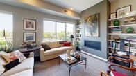 This single-floor residence at 4015 CR-25 in St. Louis Park, Minnesota, offers a well-appointed layout designed for both comfort and style. The open-concept kitchen serves as a functional centerpiece, featuring granite countertops, a large island with bar seating, sleek white cabinetry extending to the ceiling, a subway tile backsplash, and pendant lighting. Stainless steel appliances complete the polished, modern aesthetic.

The living room provides a welcoming atmosphere with large windows that frame tree-lined outdoor views, a linear fireplace built into the wall, and built-in shelving. An adjacent sitting area offers a more intimate space, with walls displaying curated gallery-style artwork throughout.

The dining area connects seamlessly to the outdoors through sliding glass doors opening to a private balcony, with a contemporary chandelier overhead and a long wooden console table along one wall. Multiple bedrooms include generous natural light; the primary bedroom features direct balcony access and a large sliding glass door, while a secondary bedroom showcases a calm, gray accent wall. Two bathrooms are finished with marble hexagonal tile flooring, wood-toned vanities, and large-format tile surrounds in both the walk-in shower and tub configurations.