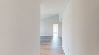 Located at 4901 Meridian Way in Frederick, Maryland, this single-floor, three-bedroom, two-bathroom home offers a clean, modern aesthetic throughout. Light wood-tone flooring runs continuously across the living areas and bedrooms, contributing to a bright and cohesive interior.

The combined kitchen and living room forms the heart of the home. The kitchen features white shaker-style cabinetry, white subway tile backsplash, light countertops, a stainless steel sink, a gas range, and a dishwasher. A pass-through window opens directly to the living room, enhancing the sense of connectivity between spaces. The living room is spacious and airy, with a glass-panel door providing outdoor access and natural light.

The primary bedroom is generously sized and benefits from multiple windows that frame outdoor views and fill the room with daylight. The two additional bedrooms are well-proportioned and share a similar bright, neutral palette. Two closets provide practical storage throughout the home.

Both bathrooms are finished with white vanity cabinetry, light countertops, and matching wood-tone flooring. One bathroom includes grab bars, adding an accessible design element. A central hallway connects the bedrooms and bathrooms efficiently. The overall ambiance is clean, modern, and move-in ready.