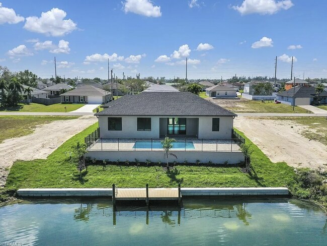 Foto del edificio - Almost New Construction Waterfront Home in NE Cape Featuring A Pool, Fenced Patio & More!