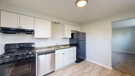 Located at 5479 Scranton Rd in Hamburg, NY, this one-bedroom, one-bathroom unit offers a practical and well-organized single-floor layout. The kitchen is a functional highlight, featuring crisp white cabinetry, dark countertops, light wood-look tile flooring, and a full suite of appliances including a gas range, stainless steel dishwasher, and a full-size refrigerator. A window above the sink brings in natural light, adding brightness to the space. The combined dining and living area flows naturally from the kitchen, offering a versatile open feel with carpeted flooring and baseboard heating. Large windows allow generous natural light and views of the surrounding greenery. The bedroom is a comfortable retreat with soft carpet, dual closet access through warm-toned wood panel doors, and additional windows that frame outdoor views on two sides. Three closets throughout the unit provide ample storage. The full bathroom is clean and functional, featuring a tiled tub-surround shower, toilet, and a white vanity with tile flooring. Neutral gray walls and consistent finishes throughout give the unit a cohesive, move-in ready appearance.