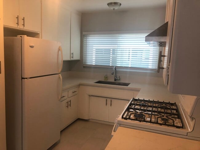 Updated kitchen with new stove - 7808 W Manchester Ave