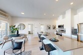 Located at 11830 SW 26 Ave in Edmonton, Alberta, this well-appointed 2-bedroom, 2-bathroom unit offers a thoughtfully designed single-level layout that maximizes functionality and comfort. The open-concept kitchen and living area serves as the heart of the home, featuring a sleek, modern kitchen with white cabinetry, stainless steel appliances, a central island with bar seating, and light hardwood flooring that flows throughout the space. Large windows in the living area flood the room with natural light and provide views of the surrounding neighbourhood, while a sliding door opens onto a private balcony.

The balcony extends the living space outdoors, offering views of the landscaped community and surrounding area. The primary bedroom is a comfortable retreat with a generous window and neutral tones. The second bedroom also benefits from natural light and built-in closet storage. A dedicated office provides a quiet, windowed workspace. Both bathrooms are finished with clean, modern tilework, with one featuring a glass-enclosed walk-in shower. Light hardwood flooring, recessed lighting, and a consistent neutral palette lend the entire unit a cohesive, contemporary ambiance.