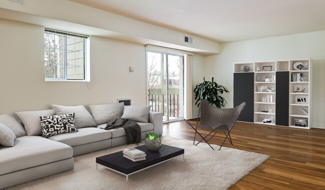 Spacious living room with vinyl wood flooring - Foxchase Apartments