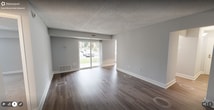 This 800 square foot single-story residence in Herndon, VA, offers a well-designed living space with one bedroom and one bathroom. The home features a modern kitchen equipped with gray cabinetry, white appliances, and a subway tile backsplash. The living area is highlighted by a large sliding glass door, providing natural light and outdoor access. The bedroom, measuring 210 square feet, includes a window and carpeted flooring for comfort. The bathroom is fitted with contemporary fixtures and a combination tub-shower. Throughout the home, neutral-toned walls and a mix of carpeted and wood-look flooring create a cohesive aesthetic. A notable feature is the well-organized closet space with adjustable wire shelving. The property's layout efficiently utilizes the available space, with two hallways connecting the various rooms. This home presents an ideal option for those seeking a low-maintenance living solution in a convenient location.